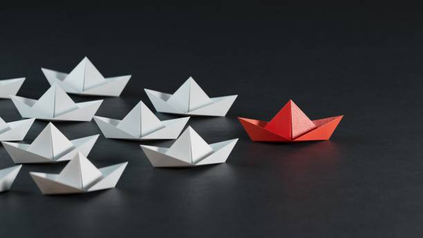 istock Different business concept.new ideas. paper art style. creative idea.Leadership concept, black leader boat leading white boats.3D rendering on black background. 2178047106