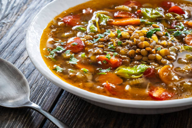 istock Fresh vegetable soup with lentil served in white bowl on wooden table 2178048183