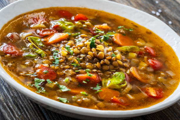 istock Fresh vegetable soup with lentil served in white bowl on wooden table 2178048192