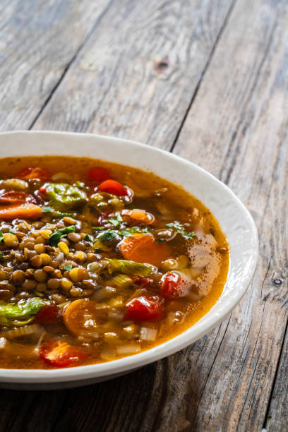 istock Fresh vegetable soup with lentil served in white bowl on wooden table 2178048200