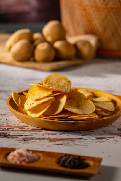 istock Potato chips on a wooden table. 2178049170