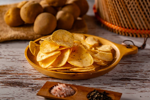 istock Potato chips on a wooden table. 2178049198