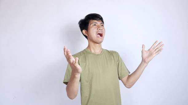 istock Shocked young Asian man looking up with both hands facing upwards 2178049370