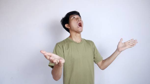 istock Shocked young Asian man looking up with both hands facing upwards 2178049523