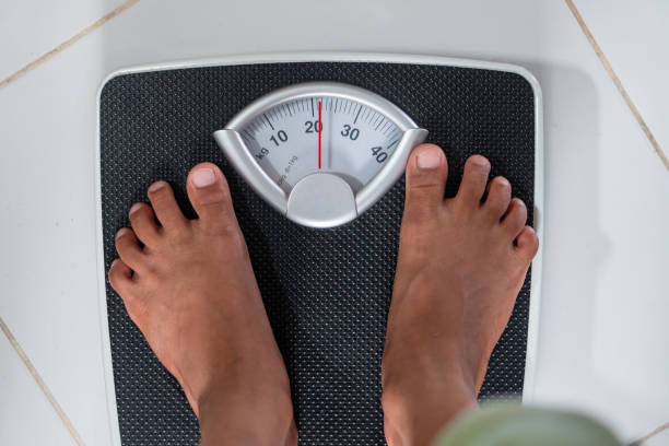 istock Person Weighing on Bathroom Scale 2178049687