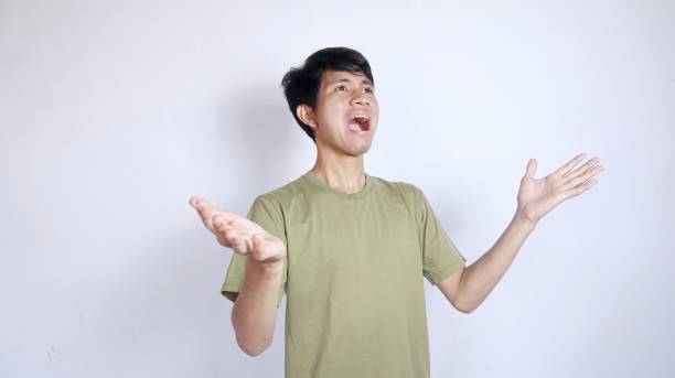 istock Shocked young Asian man looking up with both hands facing upwards 2178049824