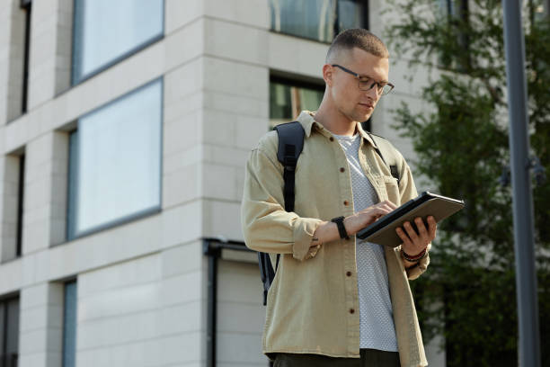 istock Male IT Specialist Using Tablet Standing Outside in Sun 2178051814