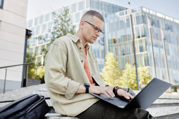 istock Businessman with Glasses Using Laptop to Work or Study Outdoors 2178051855