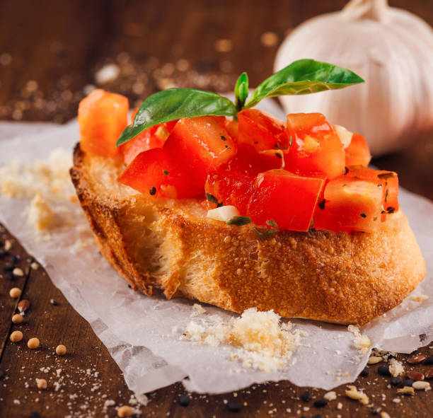 istock Delicious bruschetta with tomatoes, basil and garlic on wooden table 2178055831