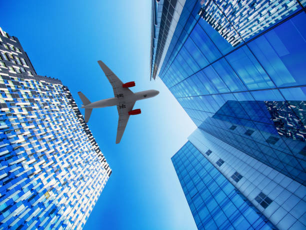 istock Airplane flying over skyscrapers 2178058733