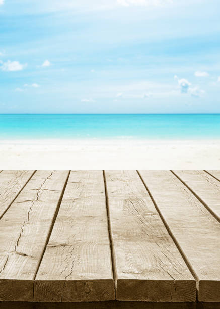 istock Empty wooden table top with beautiful tropical paradise beach background 2178058843