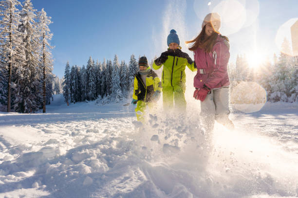 istock Carefree kids running on snowy mountain 2178060904