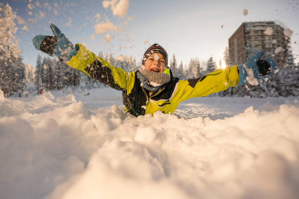 istock Boy with outstretched arms is enjoying the snow 2178061130