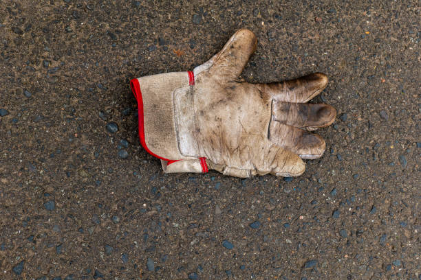 worki leather glove in dirty and used condition, isolated on white