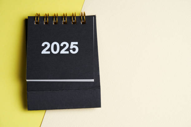 istock Small desk calendar 2025 on the yellow background 2178064886