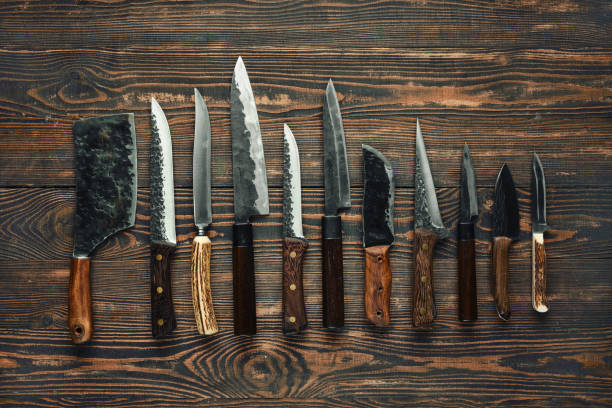 istock A collection of various kitchen knives displayed on a rustic wooden table 2178071016