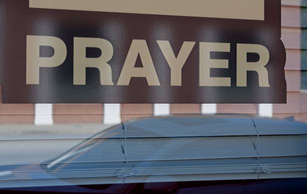 istock Prayer sign in a shop window 2178073962