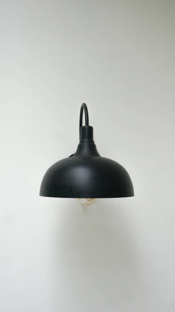 Minimalist black lampshade for a home garden on a white wall
