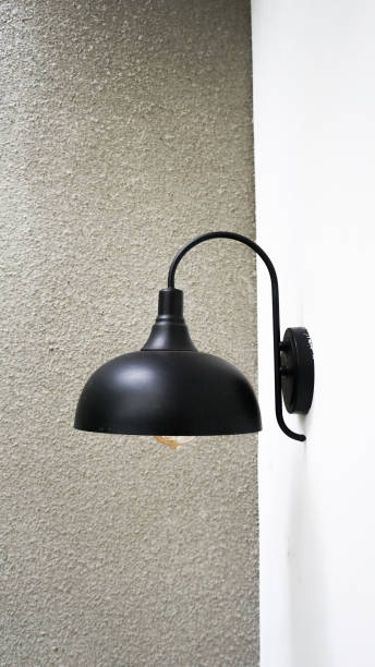 istock Minimalist black lampshade for a home garden on a white wall 2178075424