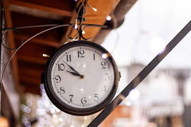 istock a round clock outside is decorated with garlands 2178075599