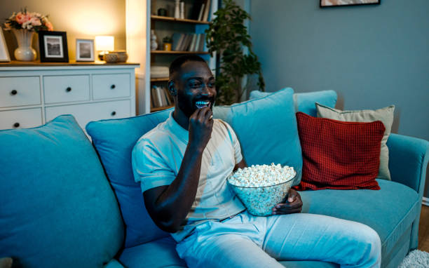 istock Man watching a movie at home 2178076134