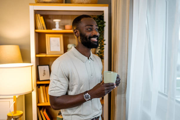 istock Young man drinking coffee at home 2178077359