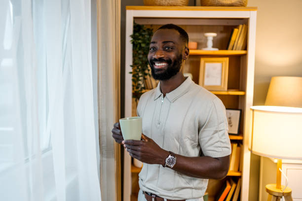 istock Young man drinking coffee at home 2178077387