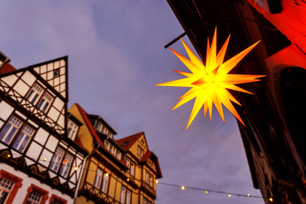 istock Charming Wernigerode town evening street view illuminated with Christmas lights garlands Herrnhutter stars on historical half-timbered houses facade. Twilight Festive city in Germany 2178077471