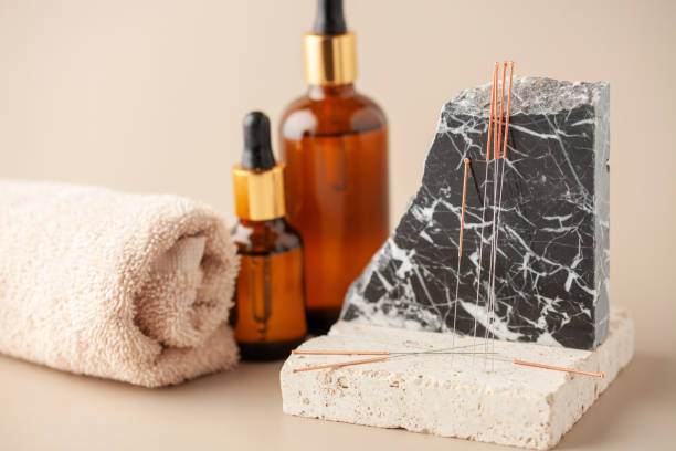 istock Acupuncture needles on a stone podium. 2178078770