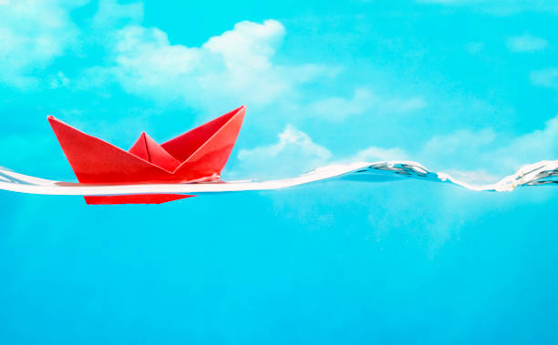istock Red paper boat sailing on water 2178082241