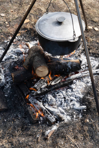 istock Camping pot with lid. Cooking food on a campfire on a hike. Fire coals. 2178084499