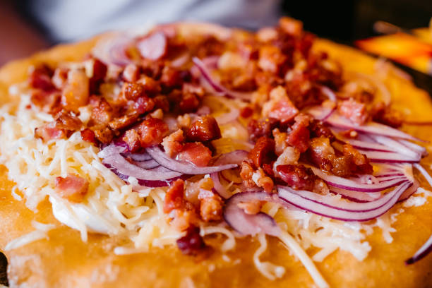 Chicken and onion pizza on the table in a bar.