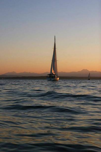 istock Serenity at Dusk: A Boat Adrift in an Orange Sunset 2178087034
