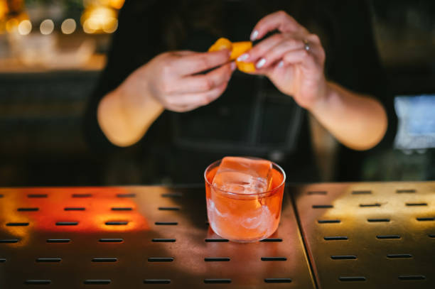 istock Bartender adding an orange zest juice to a cocktail 2178091178