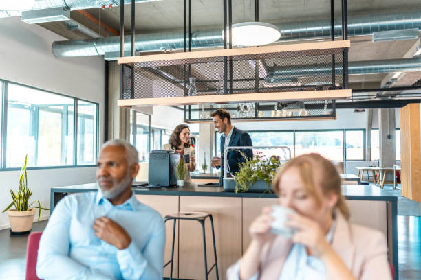 istock Mid Adult Business Colleagues Networking with Snacks in Office 2178095954