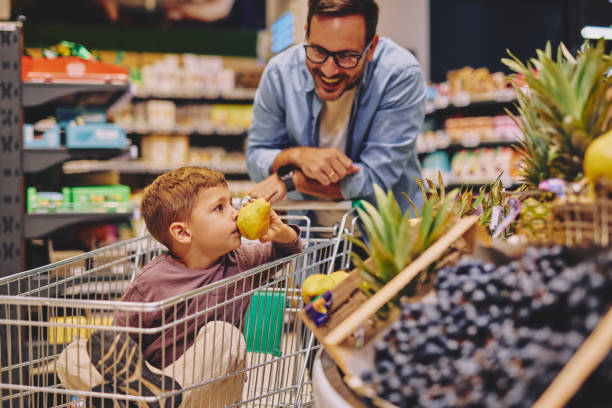 istock Father and Son Having Fun at the Grocery Store 2178096930