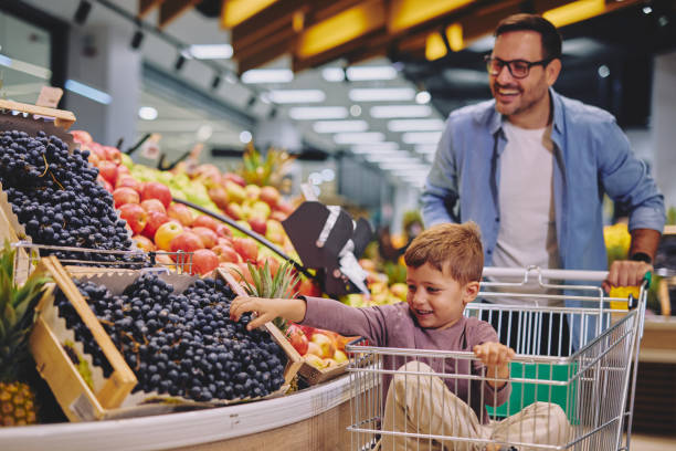 istock Father and Son Having Fun at the Grocery Store 2178096933
