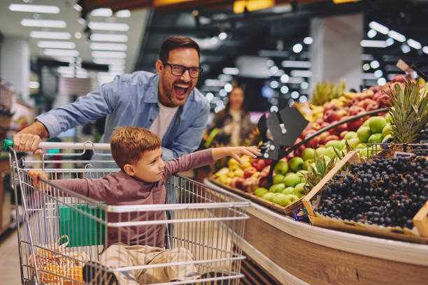 istock Father and Son Having Fun at the Grocery Store 2178097123