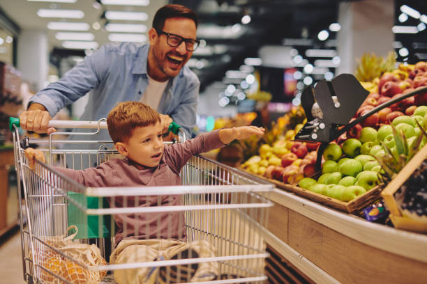 istock Father and Son Having Fun at the Grocery Store 2178097127