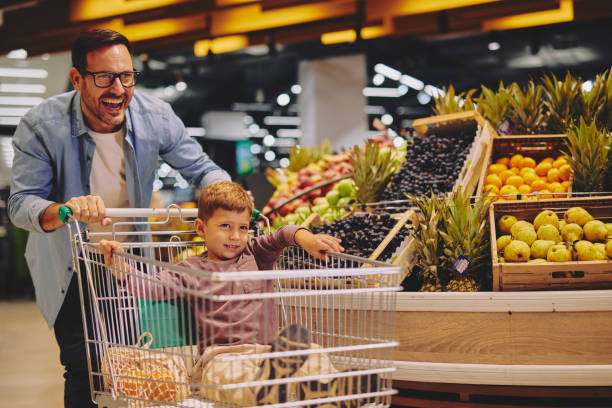 istock Father and Son Having Fun at the Grocery Store 2178097137