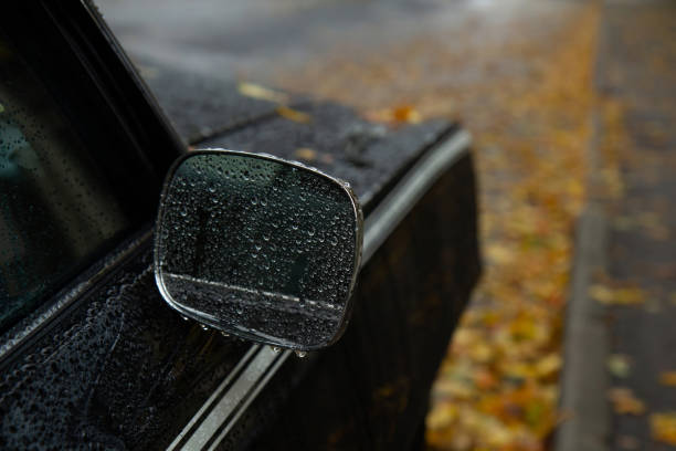 istock Car side mirror in the rain in water drops. 2178098897