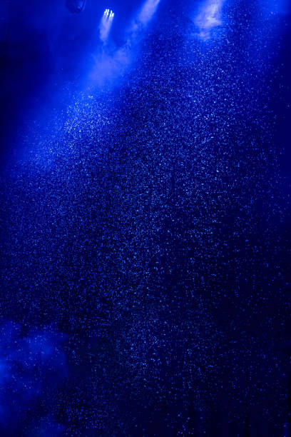 Night blue snowfall background in fog