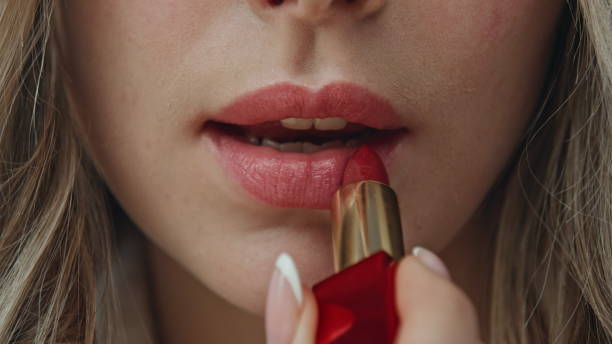istock Closeup model using lipstick at home. Macro view model making facial makeup 2178108720