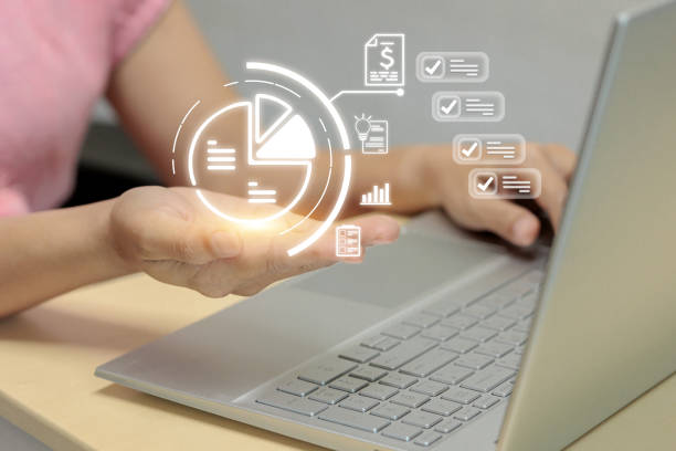istock A woman is holding a laptop with a glowing pie chart on the screen 2178109859