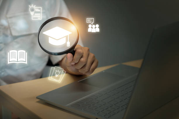istock A person is holding a magnifying glass over a laptop computer 2178109873