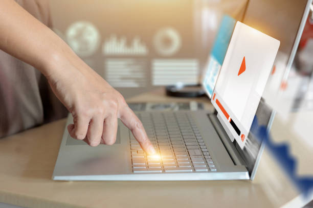 istock A person is pointing at a laptop screen with a video playing 2178109919