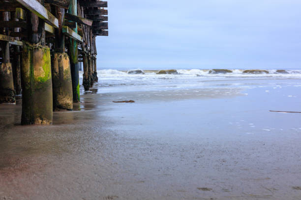 Aerial view of a pier with rough sea. Forte dei Marmi pier in Tuscany, Italy.