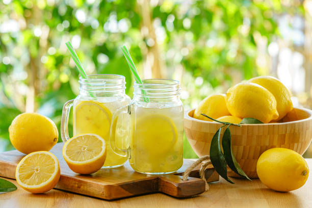 Mason jar glasses with fresh homemade lemonade on garden table