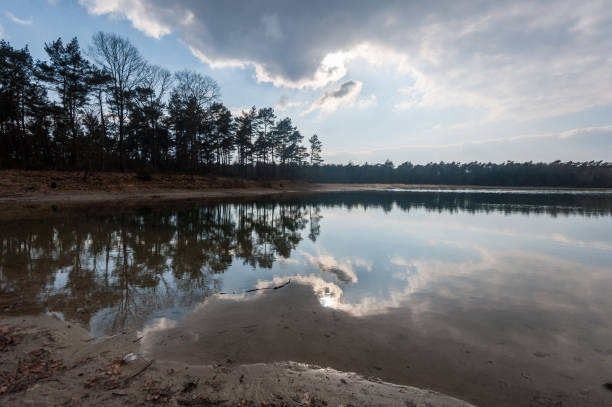 Impression of the clouds being reflected in a lake in North-eastern groningen, just before sunset