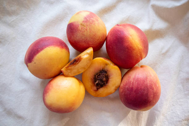 istock Fresh peaches from the orchard, both whole and sliced for immediate consumption, are on a white plate. Peaches are a sweet and tangy fruit rich in antioxidants that help nourish the skin, making it smoother, softer, and more hydrated. 2178115870